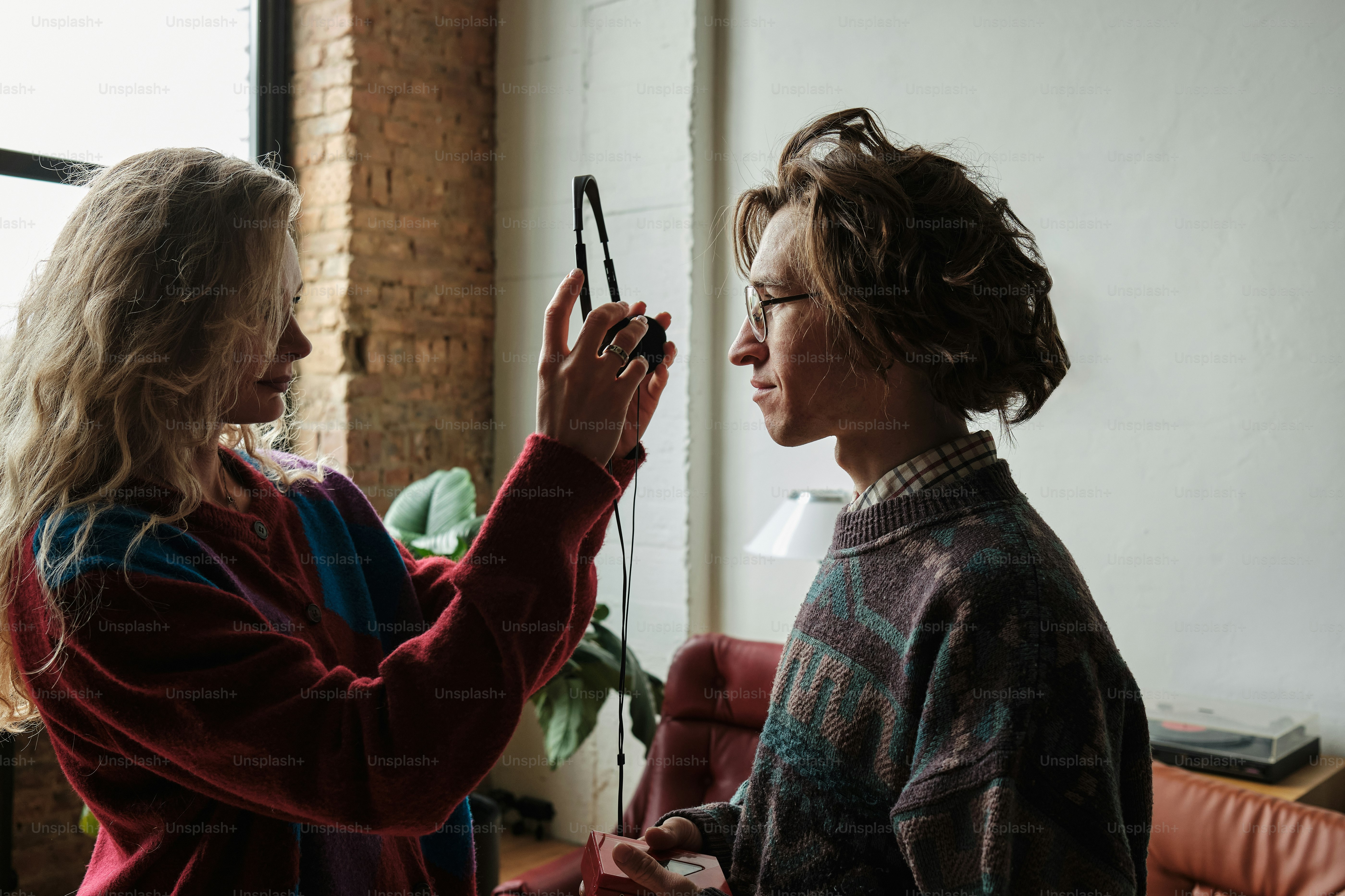 a woman holding a camera up to another woman's face