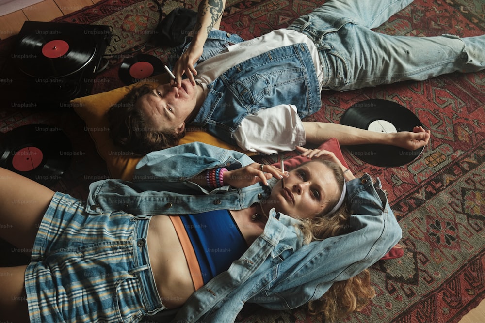 a couple of people laying on top of a rug