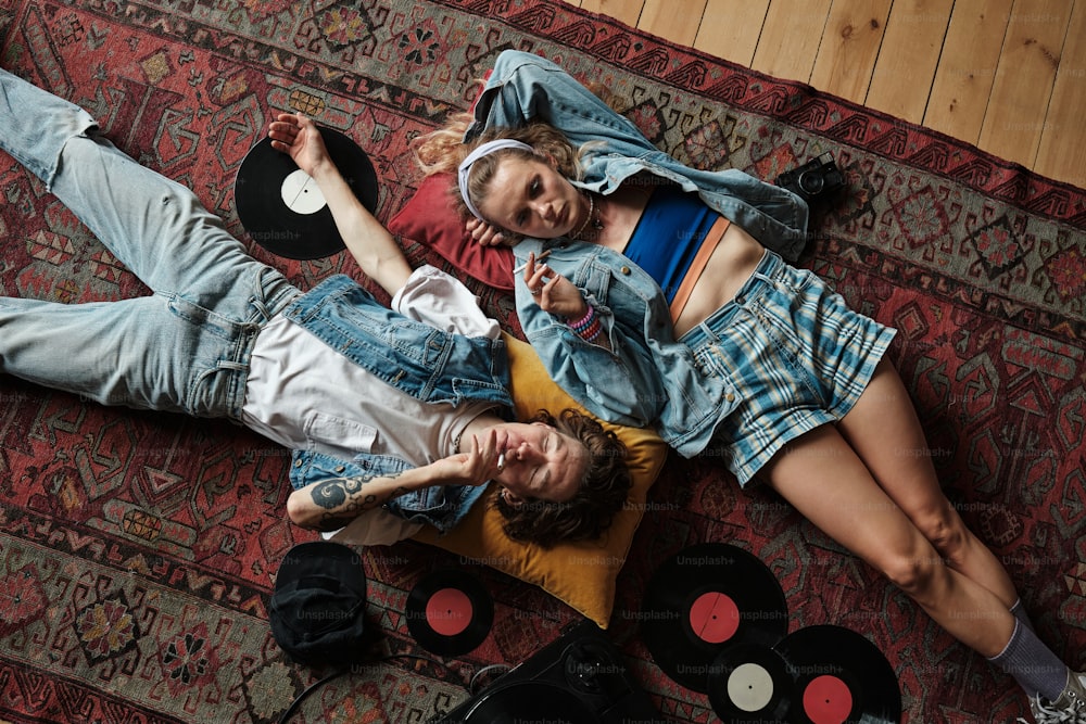 a couple of people laying on top of a rug