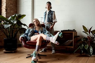 a man and a woman sitting in a chair with a skateboard