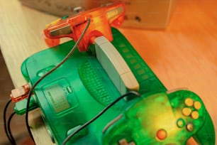 a green toy with a controller attached to it
