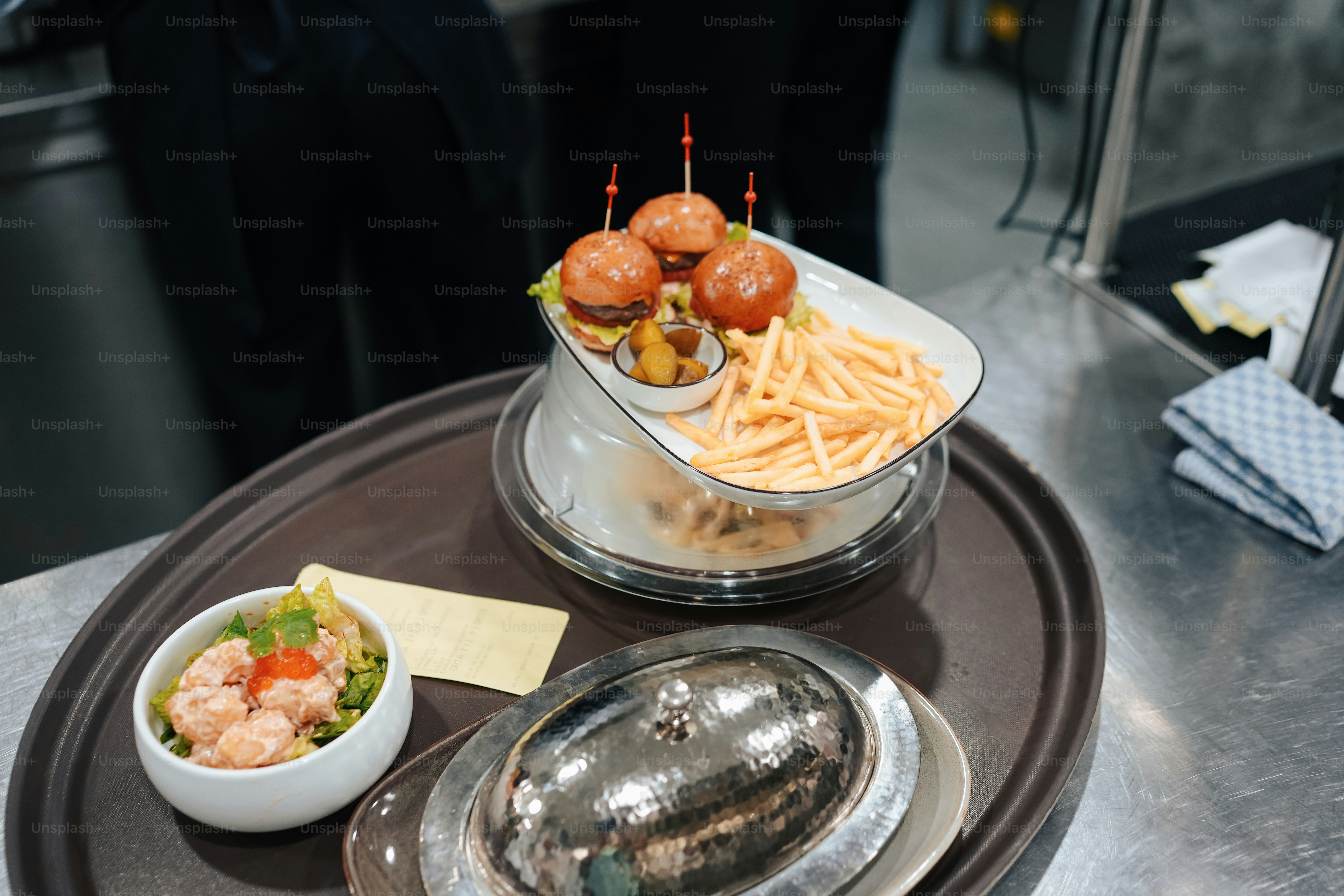 a plate of food on a table with a bowl of fries and a bowl of