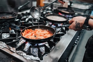 a person cooking food on a stove top