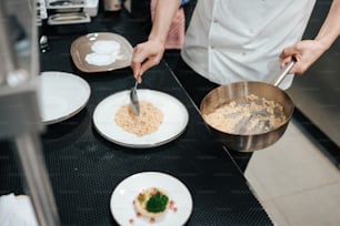 a person in a kitchen preparing food on a table