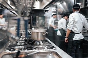a group of chefs in a kitchen preparing food