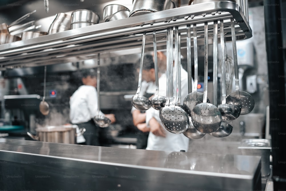 a kitchen filled with lots of metal pots and pans