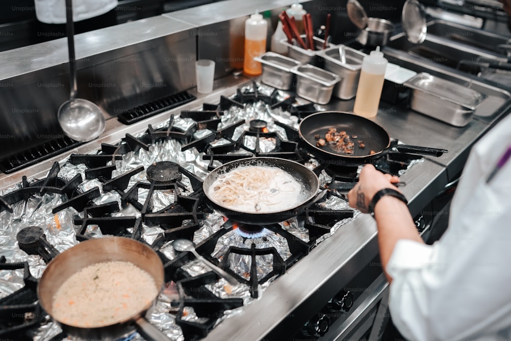 a woman cooking food on top of a stove