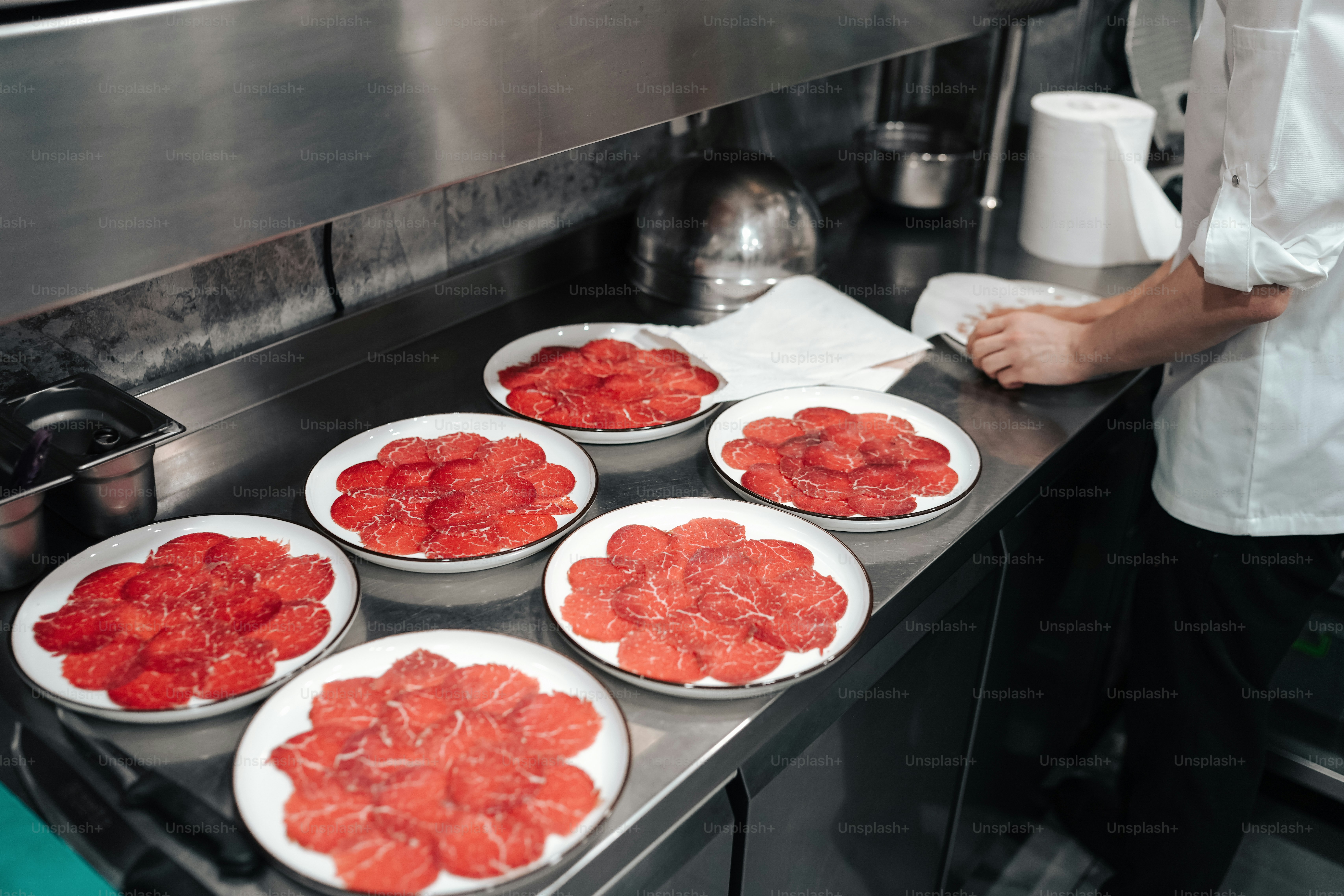 a person in a kitchen preparing food on a stove