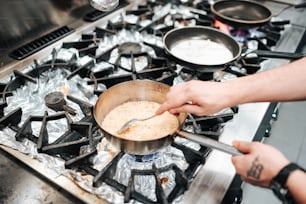 a person cooking food on top of a stove