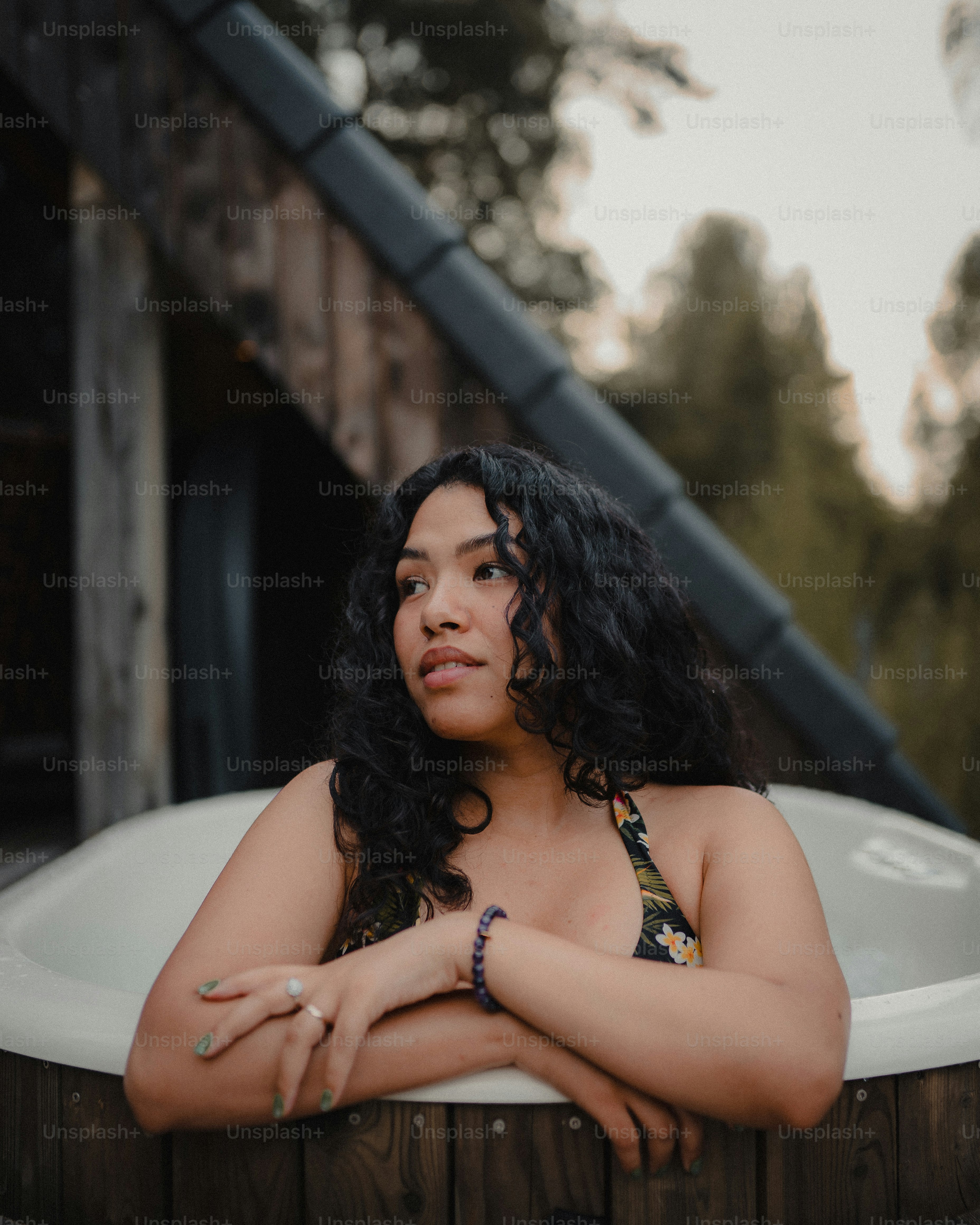 a woman in a bathing tub with her arms crossed