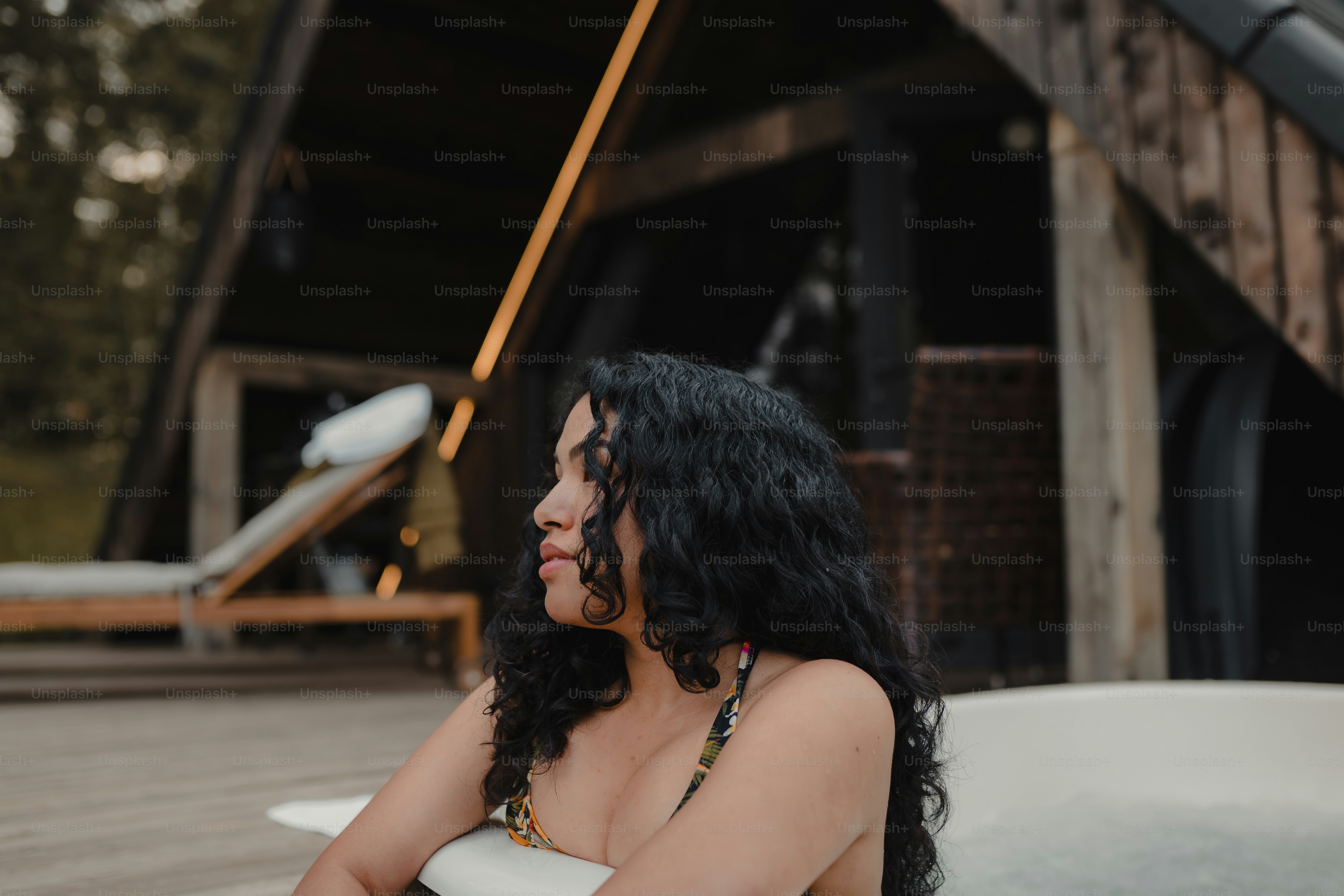 a woman in a bathing suit sitting in a hot tub