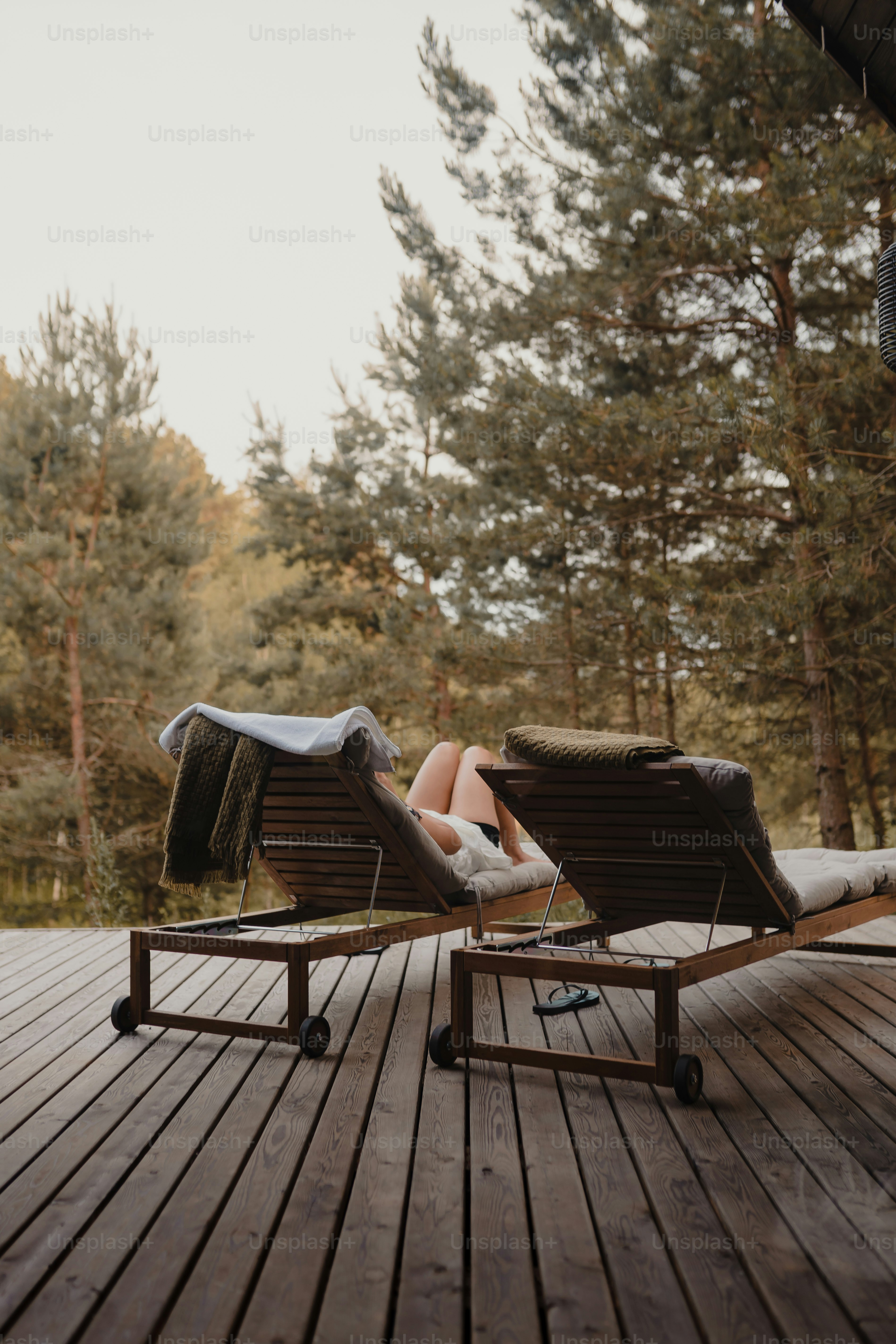a couple of chairs sitting on top of a wooden deck