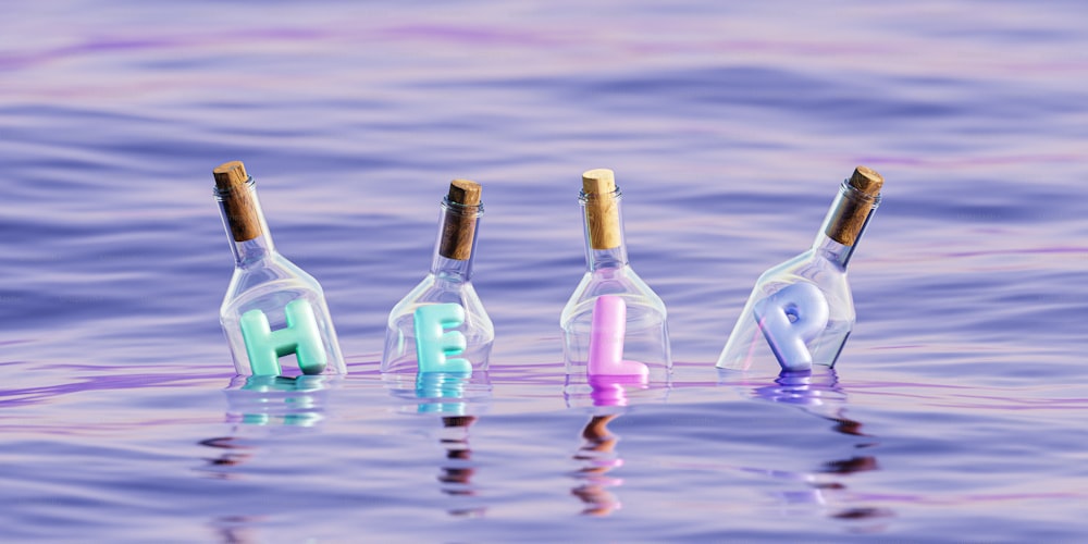a group of three wine bottles floating on top of a body of water