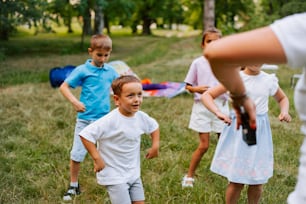 a group of young children playing a game of frisbee