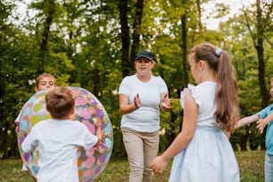 a group of children and a woman playing with a frisbee