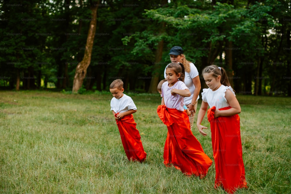 a group of young children standing in a field