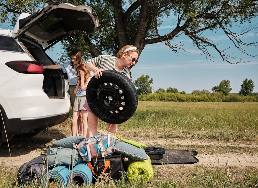 a couple of people standing next to a car