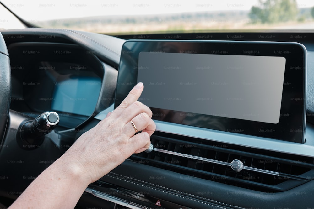 a person holding a tablet in a car