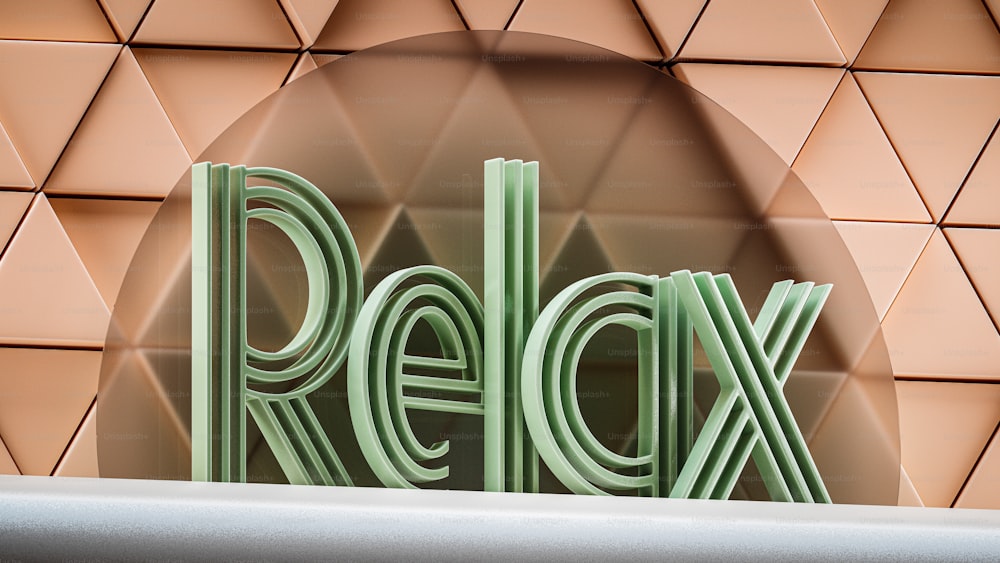 a close up of the word relax on a wall