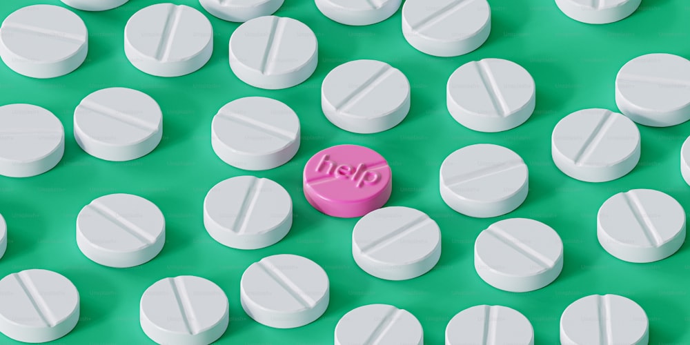 a pink pill sitting on top of white pills