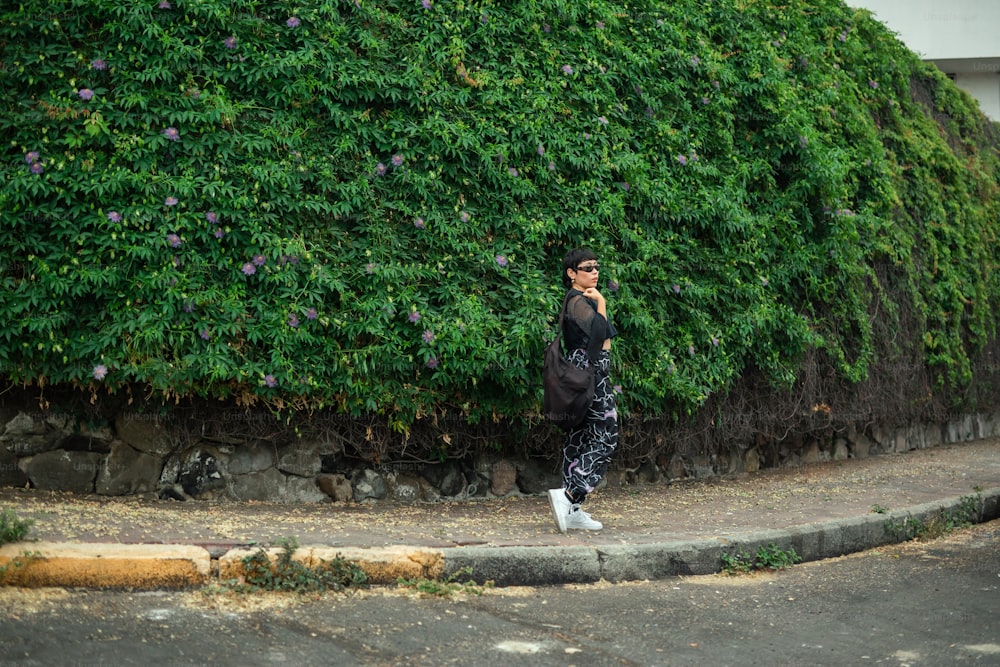 a man walking down a street while talking on a cell phone