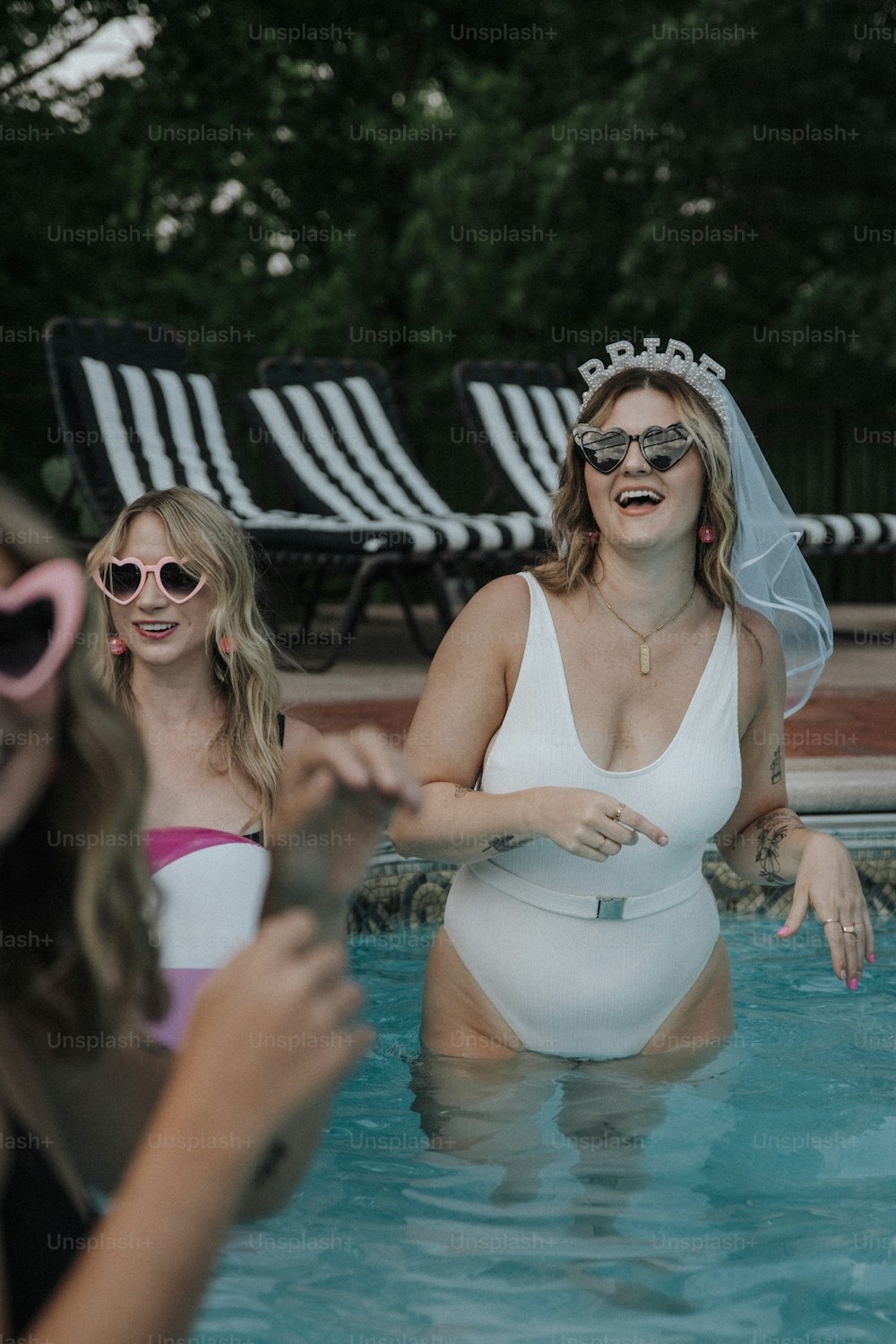 a woman in a white swimsuit standing in a pool