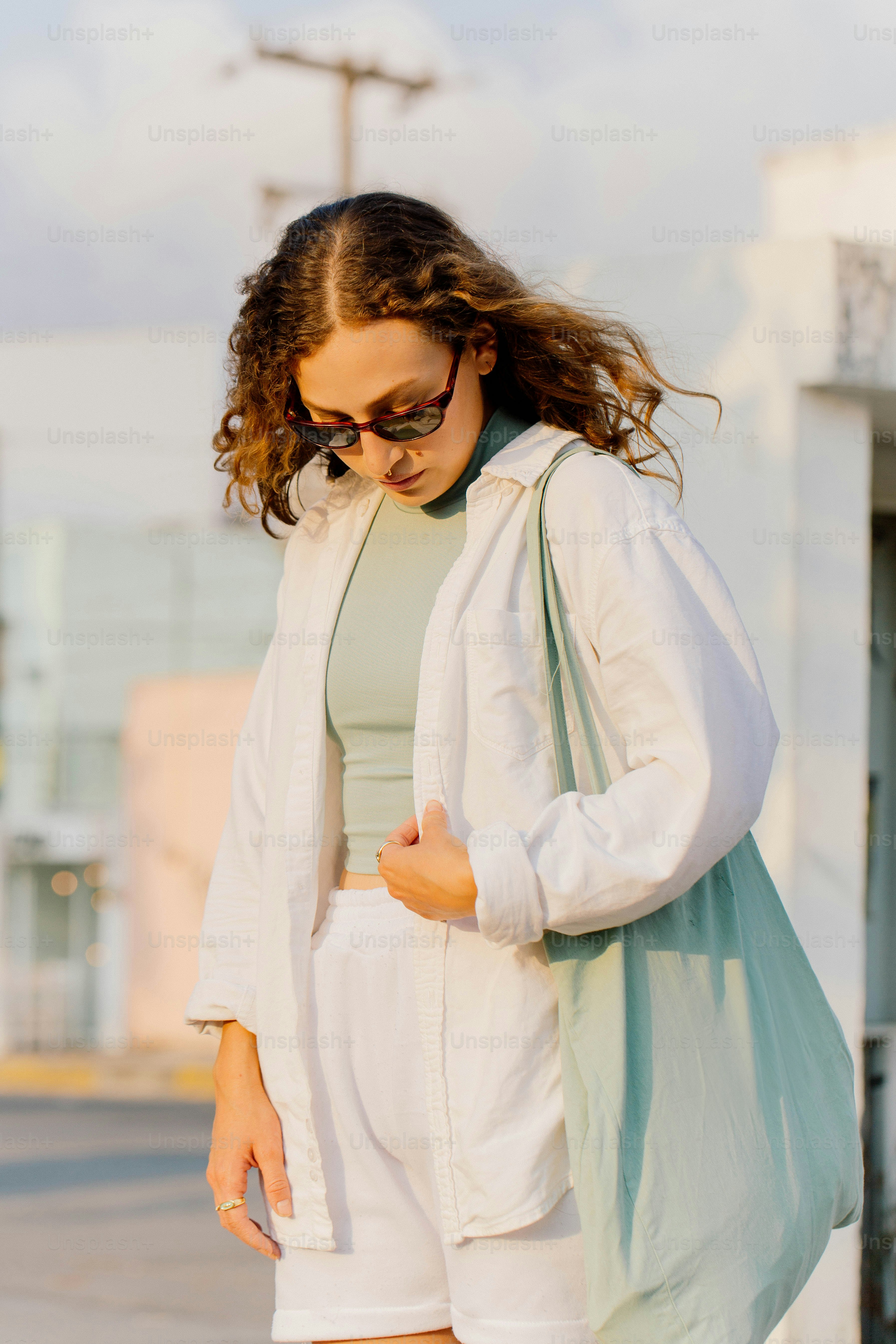 a woman wearing white shorts and a white jacket
