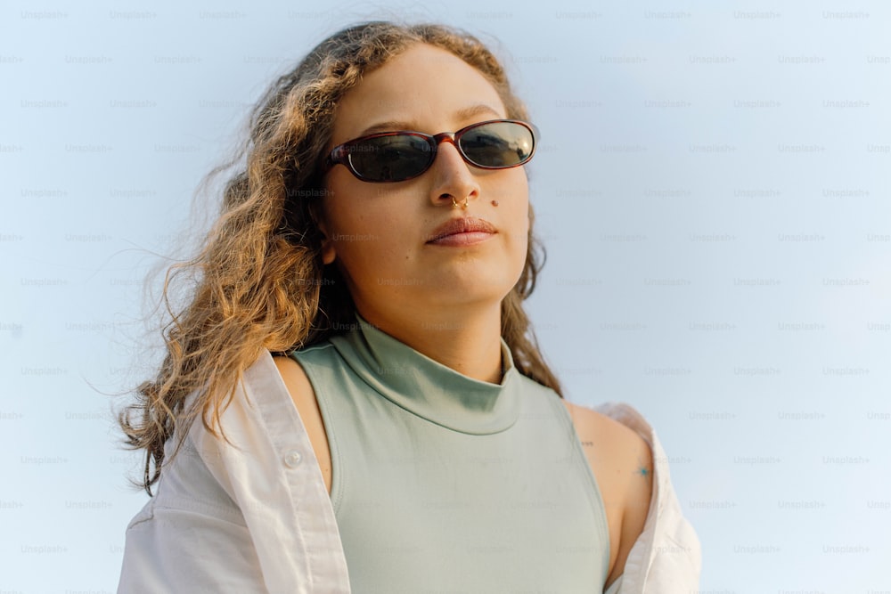 a woman wearing sunglasses and a green shirt