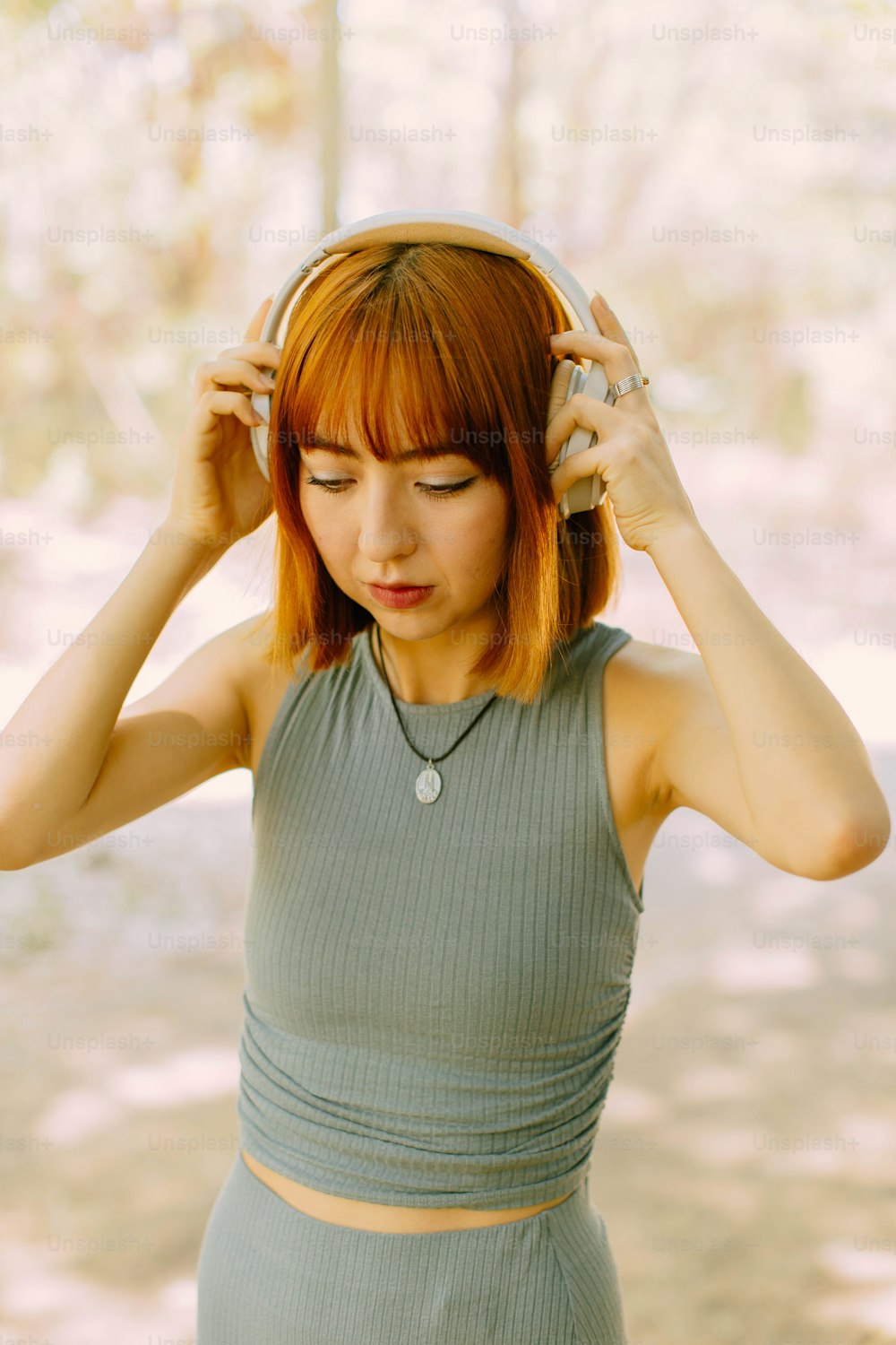 a woman with red hair is holding her head