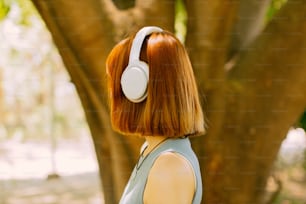 a woman with red hair wearing white headphones
