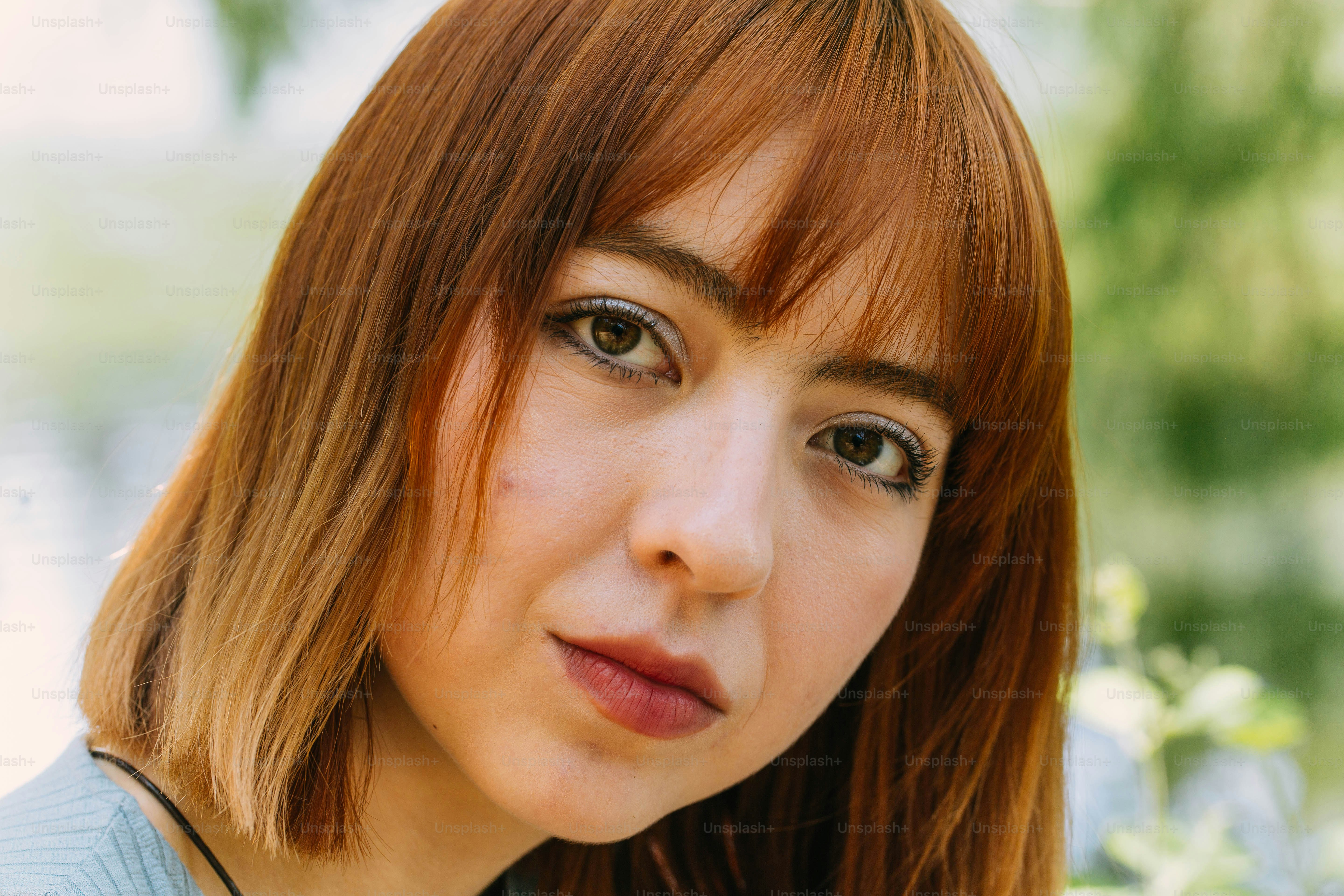 a close up of a woman with red hair