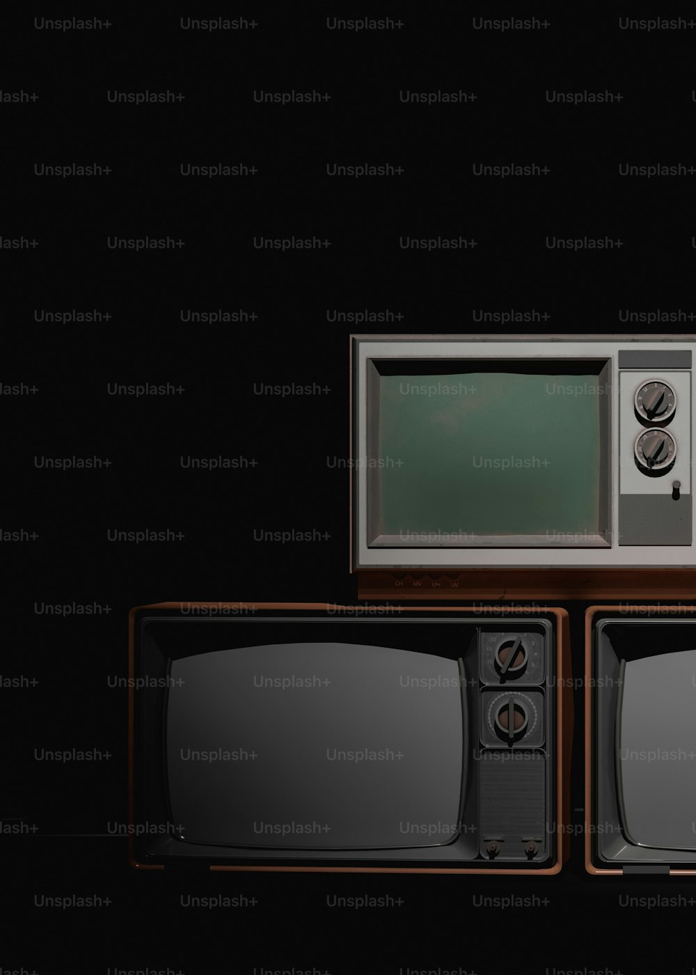two old televisions sitting on top of each other