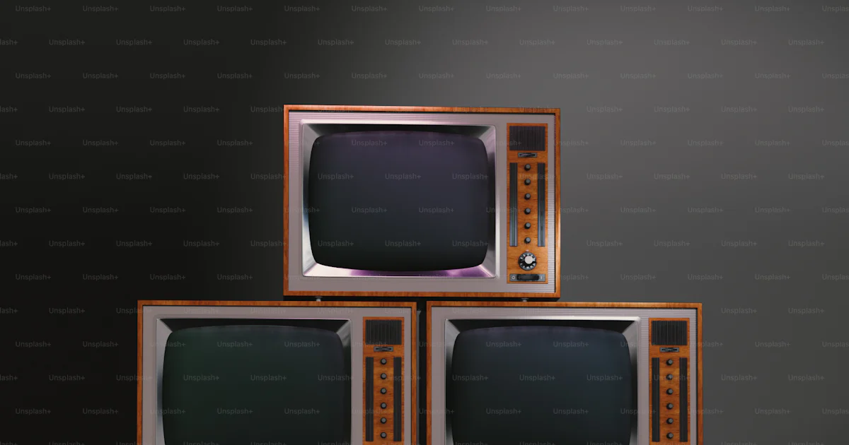 A stack of televisions sitting on top of each other photo – 80s design ...