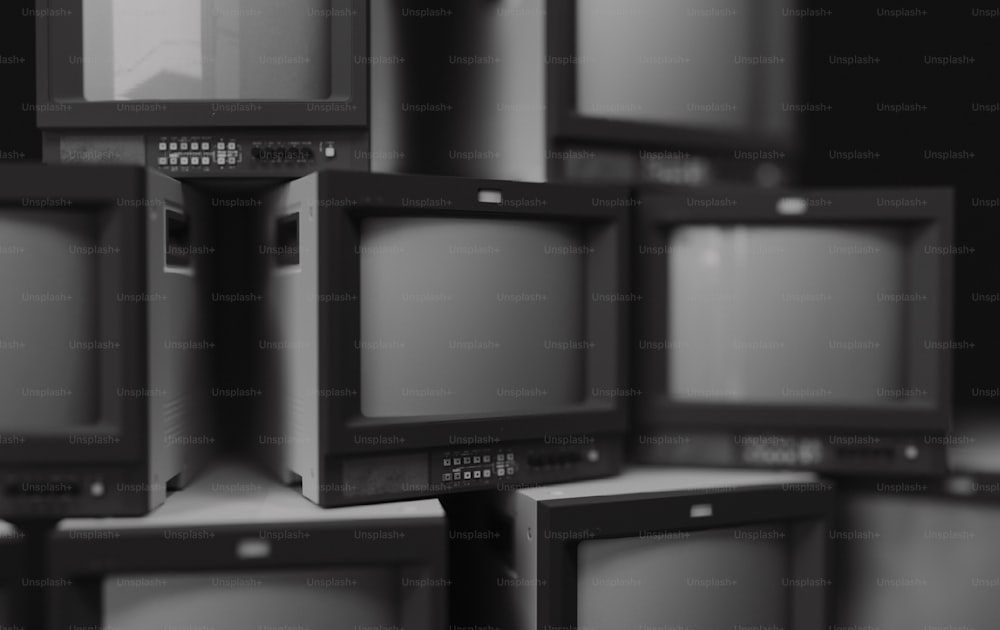 a bunch of old televisions stacked on top of each other