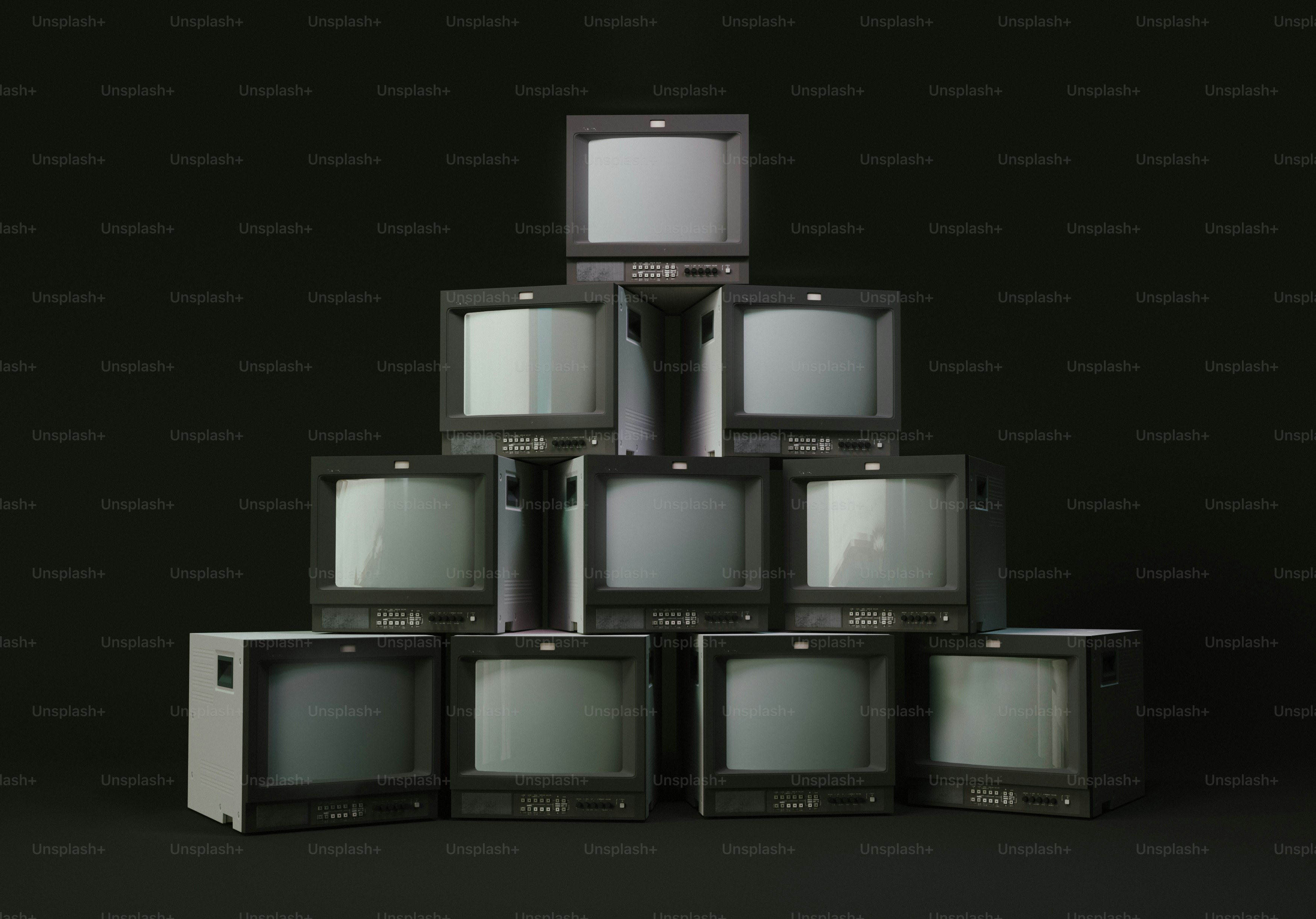 A stack of old televisions sitting on top of each other photo 90s