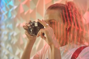 a woman taking a picture of herself with a camera