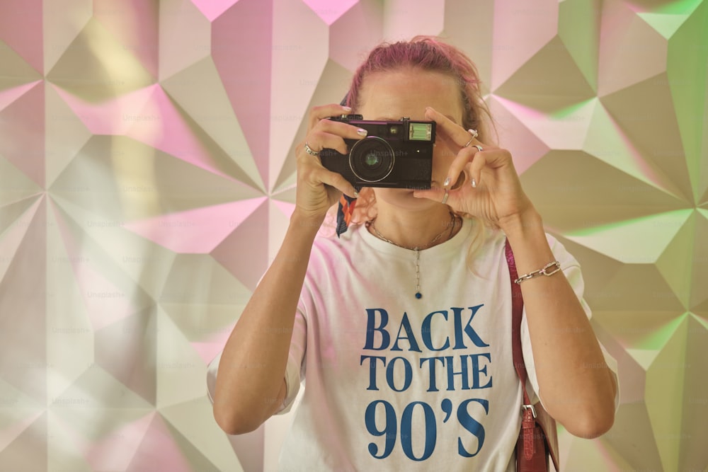 a woman taking a picture of herself with a camera