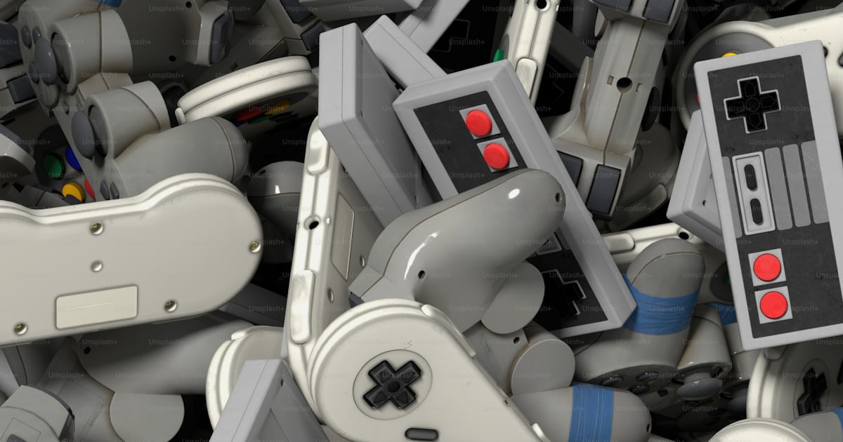 A pile of video game controllers sitting next to each other photo ...