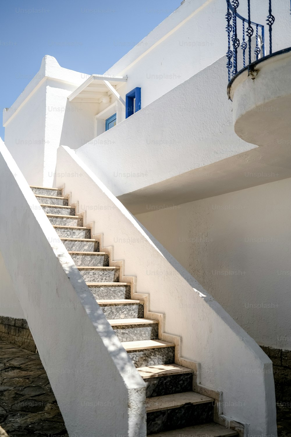 a set of stairs leading up to a white building