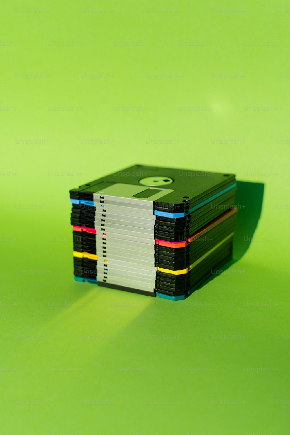 a stack of books sitting on top of a green table