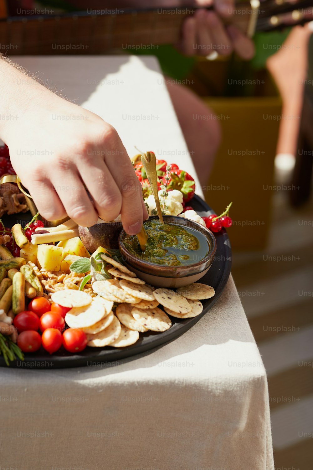 a plate of food with a person dipping sauce on top of it
