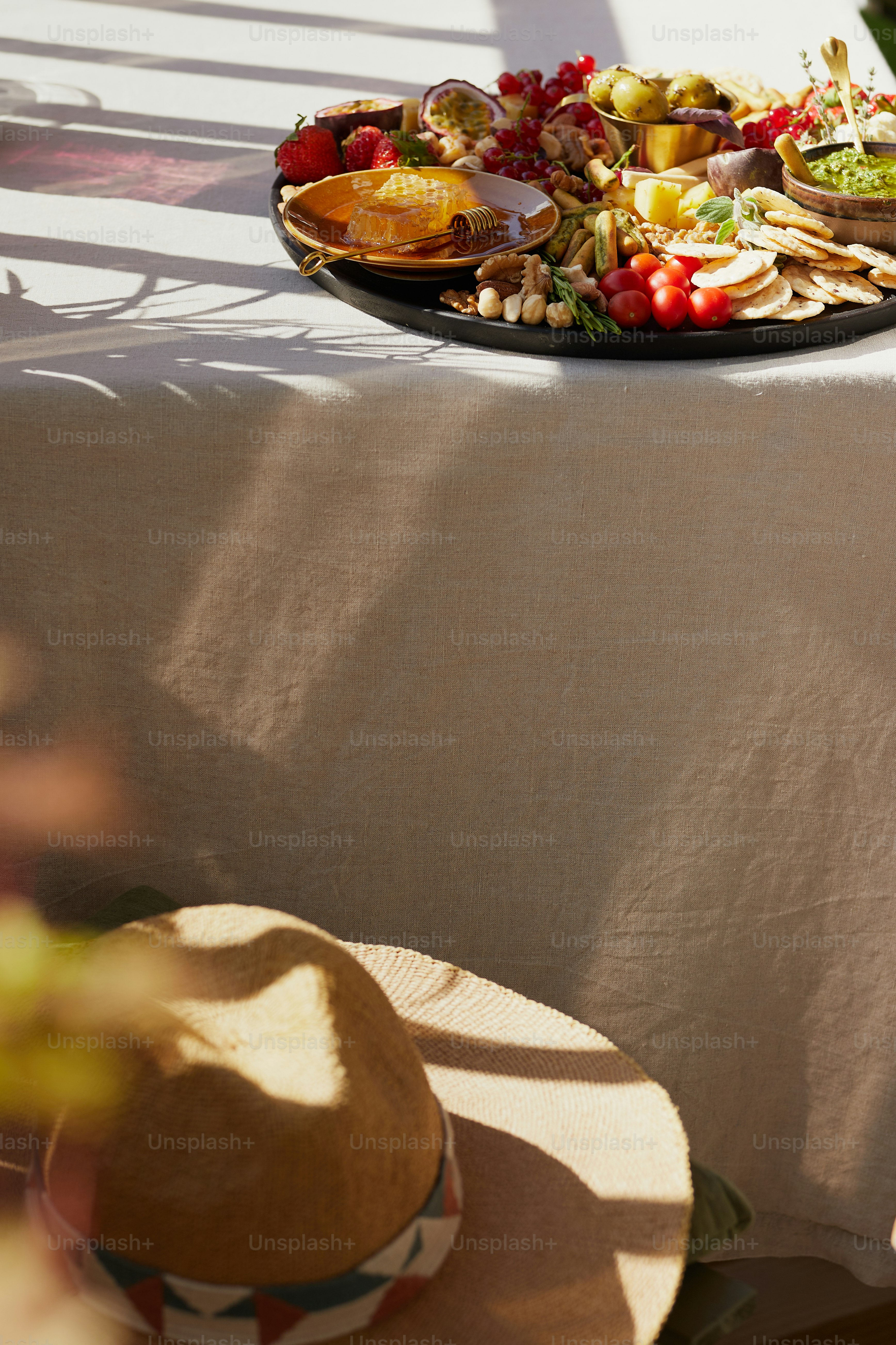 Hat on chair, and charcuterie on balcony table