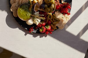 a plate of food with crackers and vegetables
