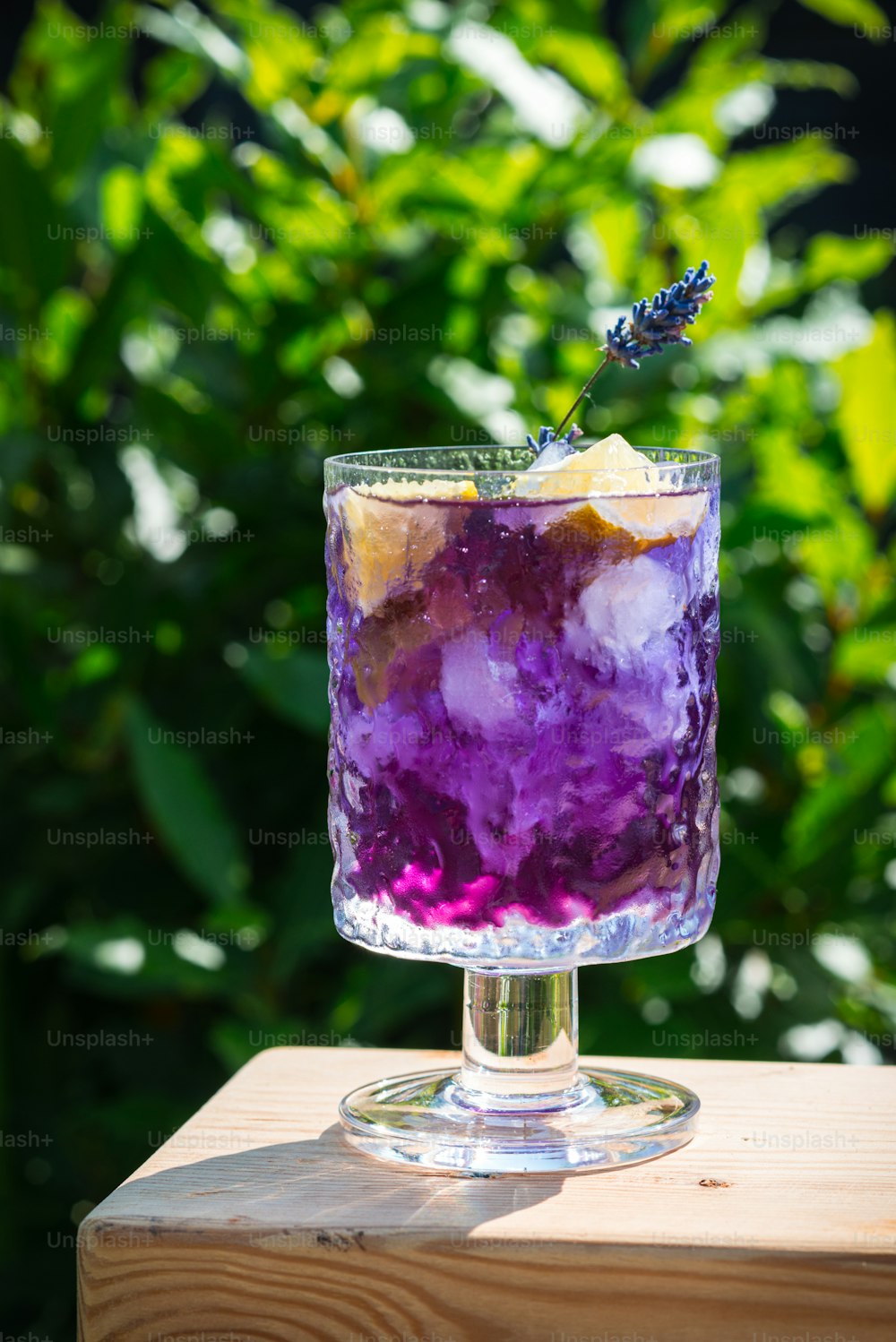 a purple drink sitting on top of a wooden table