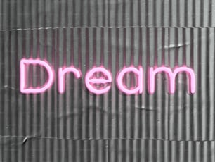 eine Leuchtreklame mit der Aufschrift Traum an einer Wand