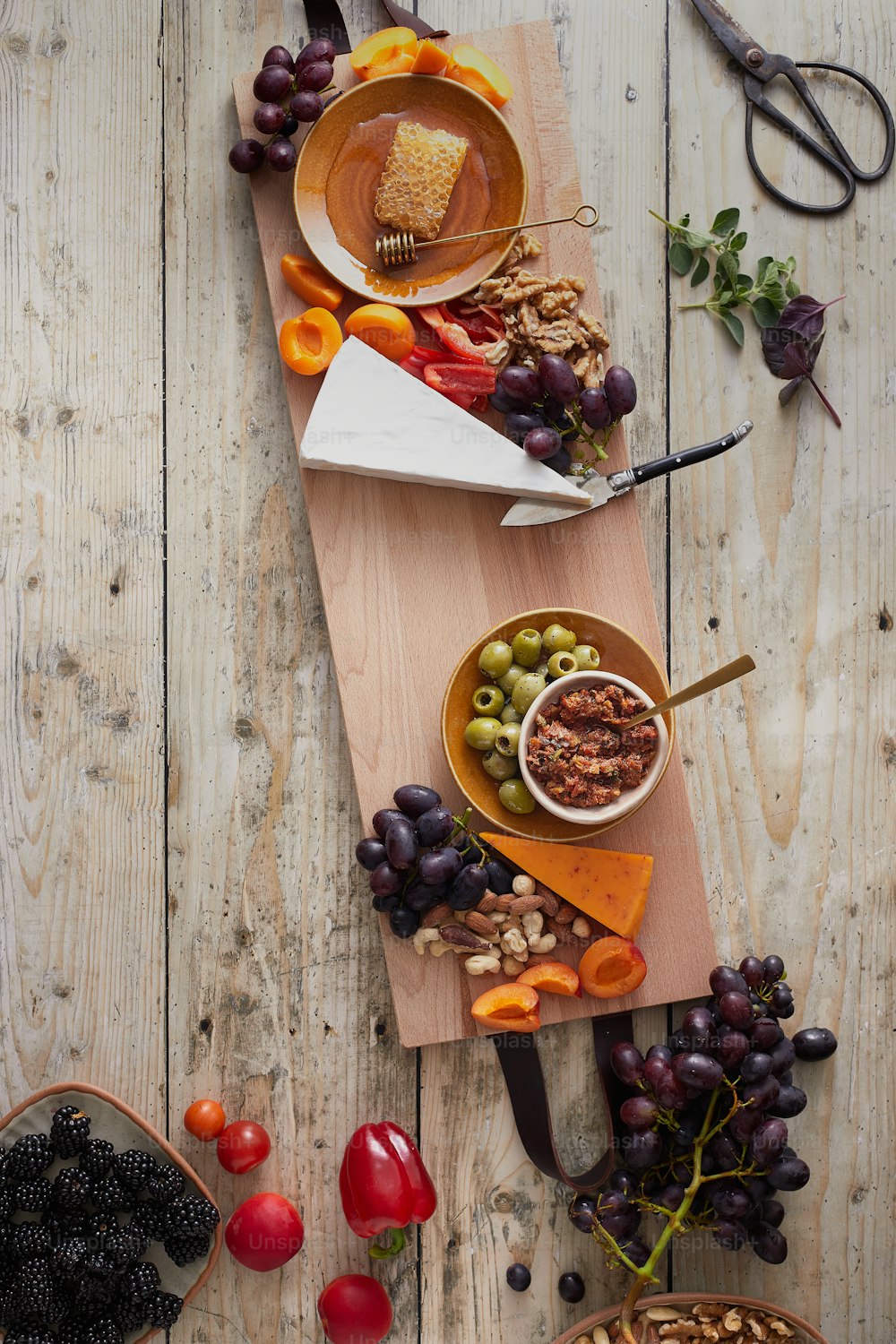 a wooden table topped with bowls of food