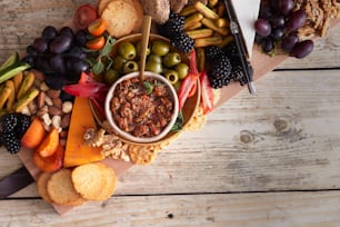 a platter of fruit, nuts, crackers, and crackers