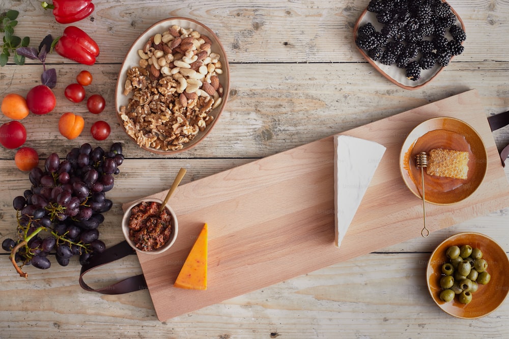 a wooden cutting board topped with different types of food