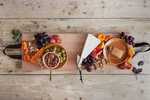 a wooden table topped with bowls of food