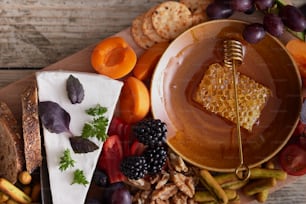 a platter of fruit, crackers, crackers, and cheese